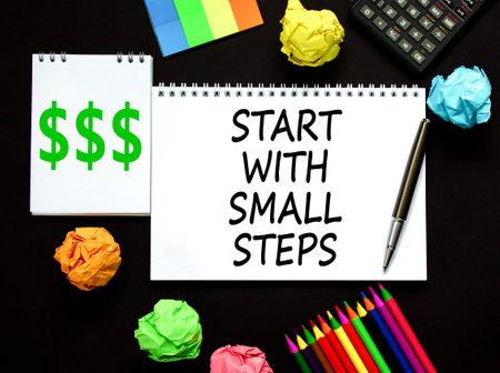 Start with small steps symbol. Concept words phrase Start with small steps on beautiful white note. Colored paper. Beautiful black background. Business Start with small steps concept. Copy spaceの写真素材