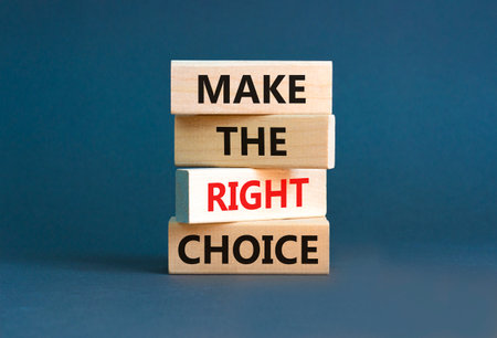 Make the right choice symbol. Concept words phrase Make the right choice on beautiful wooden blocks. Beautiful gray paper background. Business Make the right choice concept. Copy space.の写真素材