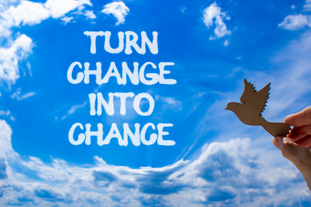 Turn change into chance symbol. Concept words phrase Turn change into chance on beautiful sky. Businessman's hand. Beautiful blue sky background. Business Turn change into chance concept. Copy space.の写真素材