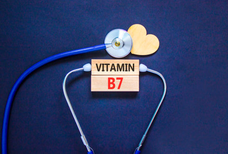 Vitamin B7 biotin symbol. Concept words Vitamin B7 on beautiful wooden blocks. Wooden heart and stethoscope. Beautiful black background. Medical healthy lifestyle Vitamin B7 concept.の写真素材