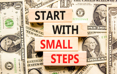 Start with small steps symbol. Concept words phrase Start with small steps on beautiful blocks. Dollar bills. Beautiful dollar bills background. Business Start with small steps concept. Copy spaceの写真素材