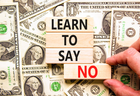 Learn to say no symbol. Concept words phrase Learn to say no on beautiful wooden blocks. Dollar bills. Beautiful dollar bills background. Business psychological Learn to say no concept. Copy space.の写真素材