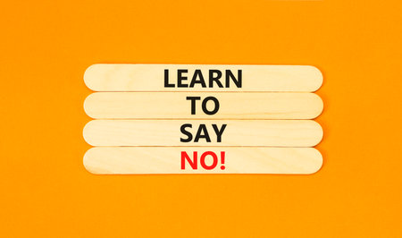 Learn to say no symbol. Concept words phrase Learn to say no on beautiful wooden stick. Beautiful orange paper background. Business psychological Learn to say no concept. Copy space.の写真素材