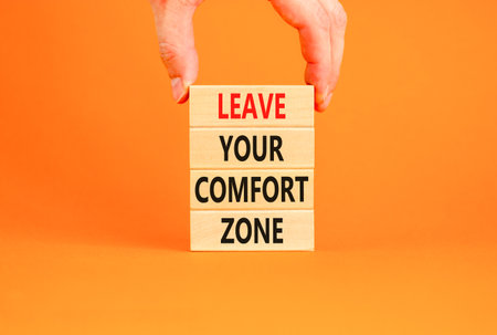 Leave your comfort zone symbol. Concept words Leave your comfort zone on beautiful wooden blocks. Beautiful orange paper background. Business psychological Leave your comfort zone concept. Copy space.の写真素材