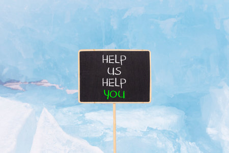 Help you symbol. Concept words phrase Help us help you on beautiful black blackboard. Beautiful blue ice background. Business Help you concept. Copy space.の写真素材