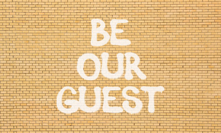 Be our guest symbol. Concept words Be our guest on beautiful brick wall. Beautiful brick wall background. Business and be our guest concept. Copy space.の写真素材