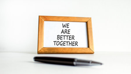 We are better together symbol. Concept words phrase We are better together on beautiful wooden picture frame. Black pen. Beautiful white background. Business We are better together concept. Copy spaceの写真素材