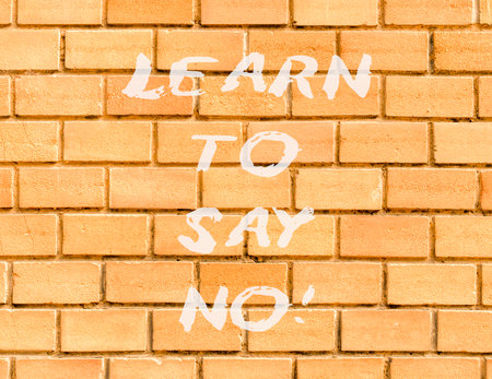 Learn to say no symbol. Concept words phrase Learn to say no on beautiful brown brick wall. Beautiful brown brick wall background. Business psychological Learn to say no concept. Copy space.の写真素材