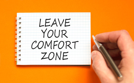 Leave your comfort zone symbol. Concept words Leave your comfort zone on beautiful white note. Beautiful orange paper background. Business psychological Leave your comfort zone concept. Copy space.の写真素材