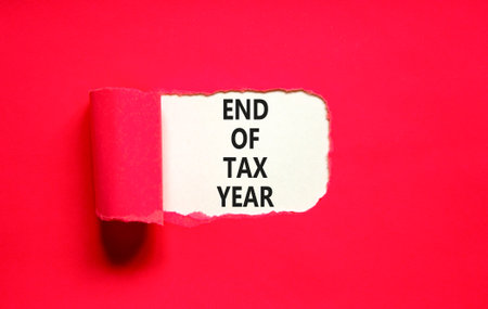 End of tax year symbol. Concept words phrase End of tax year on beautiful white paper. Beautiful red paper background. Business End of tax year concept. Copy space.の写真素材