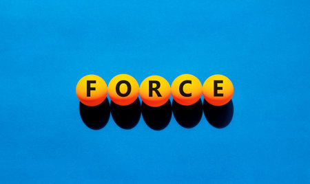 Force symbol. Concept word Force on beautiful yellow tennis ping pong balls. Beautiful wooden table wooden background. Business lifestyle force concept. Copy space.の写真素材