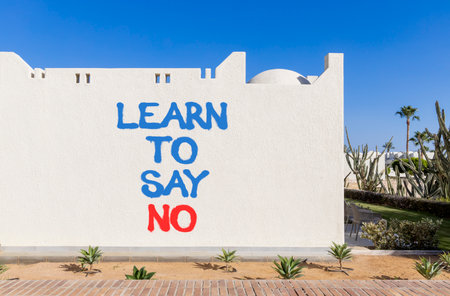Learn to say no symbol. Concept words phrase Learn to say no on beautiful white wall. Beautiful white wall and blue sky background. Business psychological Learn to say no concept. Copy space.の写真素材