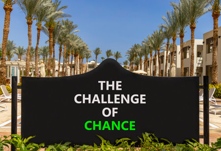 The challenge of chance symbol. Concept words phrase The challenge of chance on beautiful big black road sign. Beautiful palm blue sky background. Business The challenge of chance concept. Copy space.の写真素材