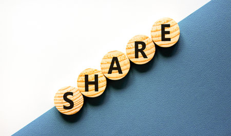 Share symbol. Concept word Share on beautiful wooden circles. Beautiful white and blue background. Business lifestyle share concept. Copy space.の写真素材