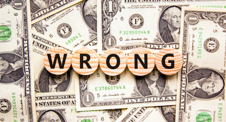 Wrong symbol. Concept word Wrong on beautiful wooden circles. Beautiful dollar bills. Beautiful background from dollar bills. Business lifestyle wrong concept. Copy space.の写真素材