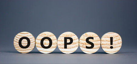 Oops symbol. Concept word Oops on beautiful wooden circles. Beautiful gray table gray background. Business lifestyle oops concept. Copy space.の写真素材