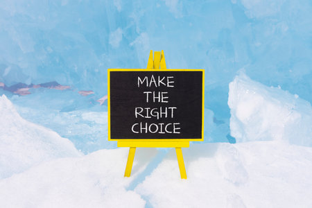 Make the right choice symbol. Concept words phrase Make the right choice on beautiful black blackboard. Beautiful blue ice background. Business Make the right choice concept. Copy space.の写真素材