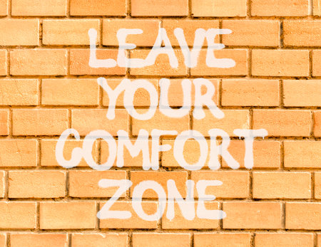 Leave your comfort zone symbol. Concept words Leave your comfort zone on beautiful brick wall. Beautiful brown brick wall background. Business psychological Leave your comfort zone concept. Copy spaceの写真素材