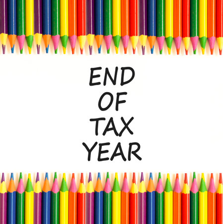 End of tax year symbol. Concept words phrase End of tax year on beautiful white paper. Colored pencils. Beautiful white paper background. Business End of tax year concept. Copy space.の写真素材
