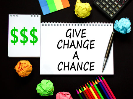 Give change a chance symbol. Concept words phrase Give change a chance on beautiful white note. Colored paper Calculator Beautiful black background. Business Give change a chance concept. Copy space.の写真素材