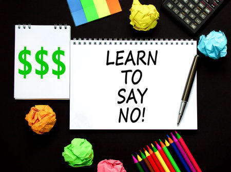 Learn to say no symbol. Concept words phrase Learn to say no on beautiful white note. Colored paper. Calculator. Beautiful black background. Business psychological Learn to say no concept. Copy spaceの写真素材