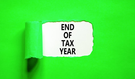 End of tax year symbol. Concept words phrase End of tax year on beautiful white paper. Beautiful green paper background. Business End of tax year concept. Copy space.の写真素材