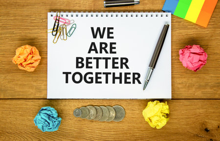 We are better together symbol. Concept words phrase We are better together on beautiful white note. Colored paper. Beautiful wooden background. Business We are better together concept. Copy spaceの写真素材
