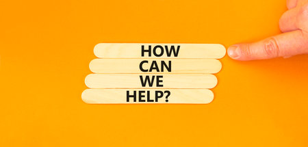 How can we help symbol. Concept words How can we help on beautiful wooden sticks. Beautiful orange...