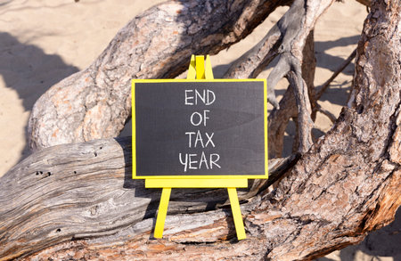 End of tax year symbol. Concept words phrase End of tax year on beautiful black blackboard....