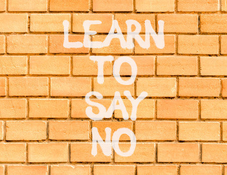 Learn to say no symbol. Concept words phrase Learn to say no on beautiful brown brick wall. Beautiful brown brick wall background. Business psychological Learn to say no concept. Copy space.の写真素材