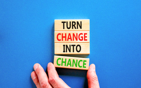 Turn change into chance symbol. Concept words phrase Turn change into chance on beautiful wooden blocks. Beautiful blue paper background. Business Turn change into chance concept. Copy space.の写真素材