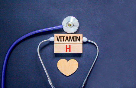 Vitamin H symbol. Concept words Vitamin H on beautiful wooden blocks. Wooden heart and stethoscope. Beautiful black background. Medical healthy lifestyle Vitamin H concept.の写真素材