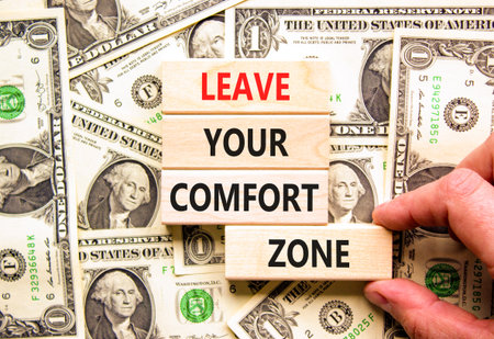 Leave your comfort zone symbol. Concept words Leave your comfort zone on beautiful wooden blocks. Beautiful dollar bills background. Business psychological Leave your comfort zone concept. Copy space.の写真素材