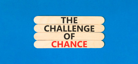The challenge of chance symbol. Concept words phrase The challenge of chance on beautiful wooden stick. Beautiful blue paper background. Business The challenge of chance concept. Copy space.の写真素材