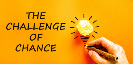 The challenge of chance symbol. Concept words phrase The challenge of chance on beautiful paper. Businessman's hand. Beautiful orange background. Business The challenge of chance concept. Copy space.の写真素材