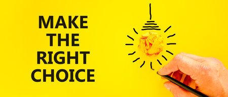 Make the right choice symbol. Concept words phrase Make the right choice on beautiful yellow paper. Businessman's hand. Beautiful yellow background. Business Make the right choice concept. Copy space.の写真素材