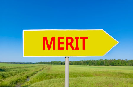 Merit symbol. Concept word Merit on beautiful yellow road sign. Beautiful blue sky green grass and forest peaceful nature background. Business lifestyle merit concept. Copy space.の写真素材