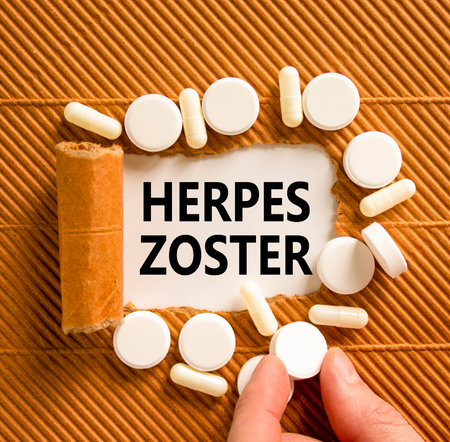 Herpes zoster symbol. Concept words Herpes zoster on beautiful white paper. White pills tablets. Doctor's hand. Beautiful brown background. Medical healthy lifestyle herpes zoster concept.の写真素材