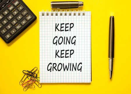 Keep going and growing symbol. Concept words phrase Keep going keep growing on beautiful white note. Calculator. Beautiful yellow background. Business Keep going and growing concept. Copy space.の写真素材