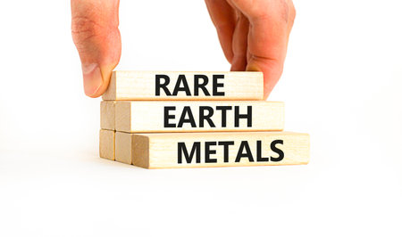 Rare earth metals symbol. Concept words Rare earth metals on beautiful wooden block. Businessman's hand. Beautiful white background. Business and rare earth metals concept. Copy space.の写真素材