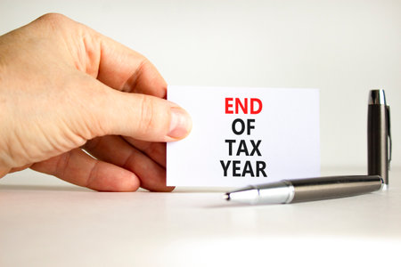 End of tax year symbol. Concept words phrase End of tax year on beautiful white card. Businessman's...