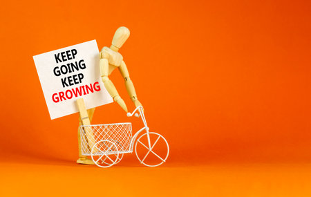 Keep going and growing symbol. Concept words phrase Keep going keep growing on beautiful white paper on clothespin. Beautiful orange paper background. Business Keep going growing concept. Copy space.の写真素材