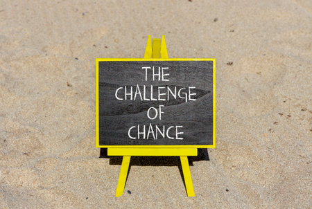 The challenge of chance symbol. Concept words phrase The challenge of chance on beautiful black blackboard. Beautiful sand beach background. Business The challenge of chance concept. Copy space.の写真素材