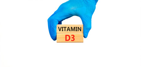 Vitamin D3 symbol. Concept words Vitamin D3 on beautiful wooden blocks. Doctor's hand in blue medical glove. Beautiful white background. Medical healthy lifestyle Vitamin D3 concept.の写真素材