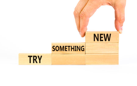 Try something new symbol. Concept words Try something new on beautiful block. Businessman's hand. Beautiful white background. Business motivational lifestyle try something new concept. Copy space.の写真素材