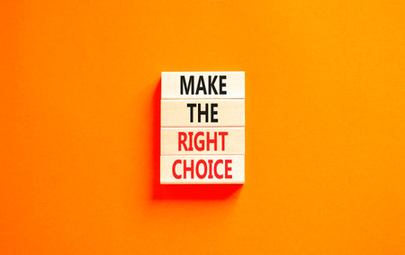 Make the right choice symbol. Concept words phrase Make the right choice on beautiful wooden blocks. Beautiful orange paper background. Business Make the right choice concept. Copy space.の写真素材