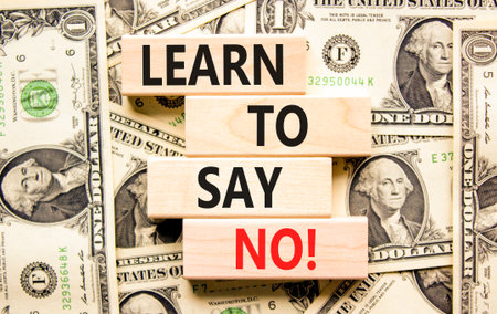 Learn to say no symbol. Concept words phrase Learn to say no on beautiful wooden blocks. Dollar bills. Beautiful dollar bills background. Business psychological Learn to say no concept. Copy space.の写真素材