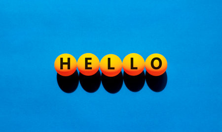 Hello symbol. Concept word Hello on beautiful yellow tennis ping pong balls. Beautiful wooden table wooden background. Business lifestyle hello concept. Copy space.の写真素材