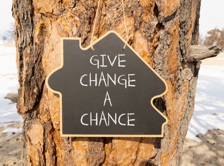 Give change a chance symbol. Concept words phrase Give change a chance on beautiful black blackboard. Beautiful old pine tree background. Business Give change a chance concept. Copy space.の写真素材