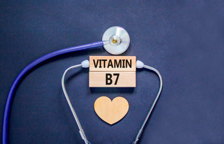Vitamin B7 biotin symbol. Concept words Vitamin B7 on beautiful wooden blocks. Wooden heart and stethoscope. Beautiful black background. Medical healthy lifestyle Vitamin B7 concept.の写真素材